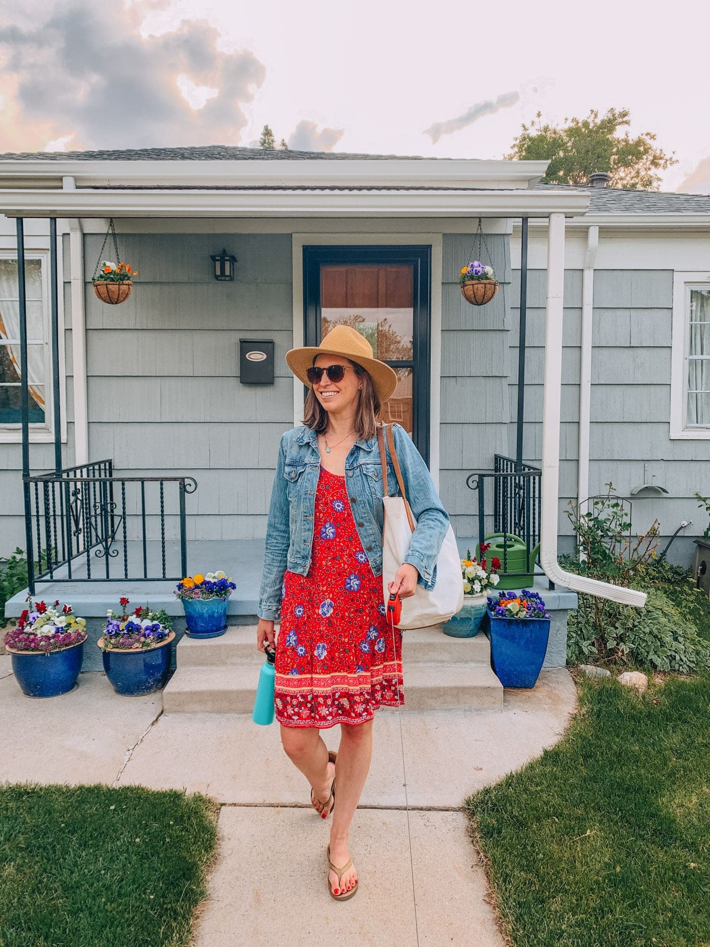 Wearing a Red floral sundress with jean jacket and wide brim hat